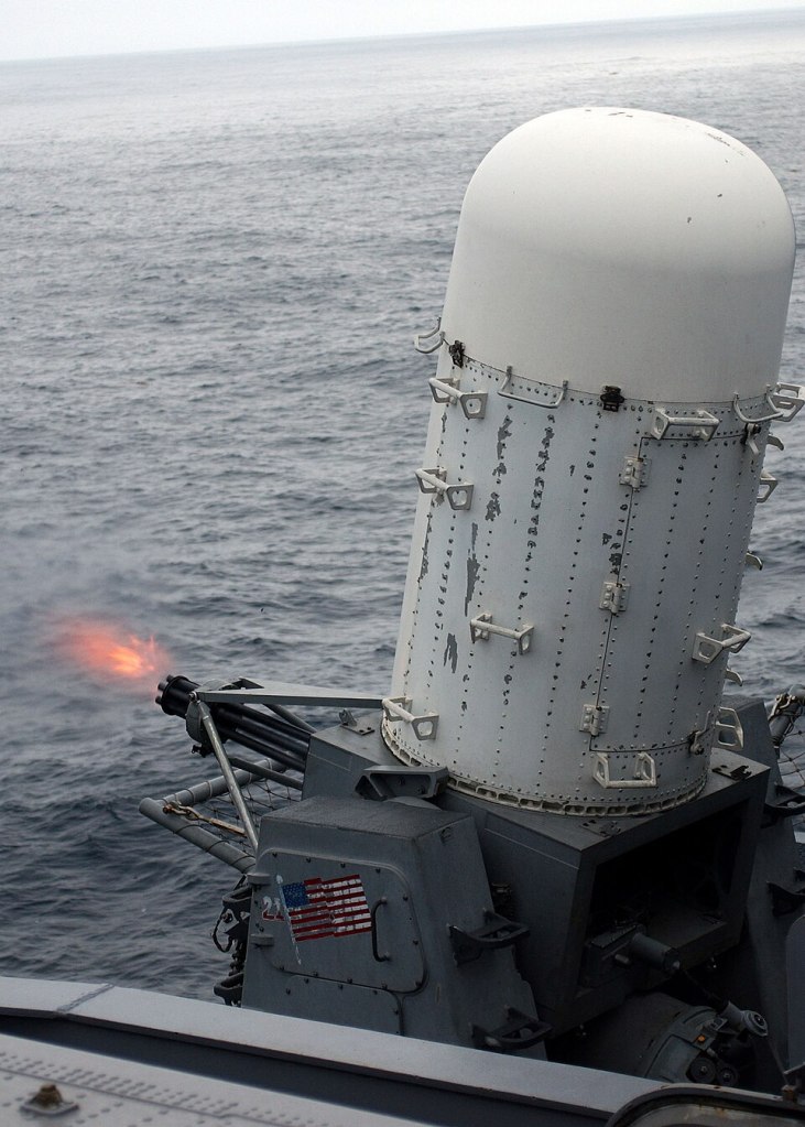 Sistema de defesa antiaérea em operação, com lançamento de projétil sobre o oceano.